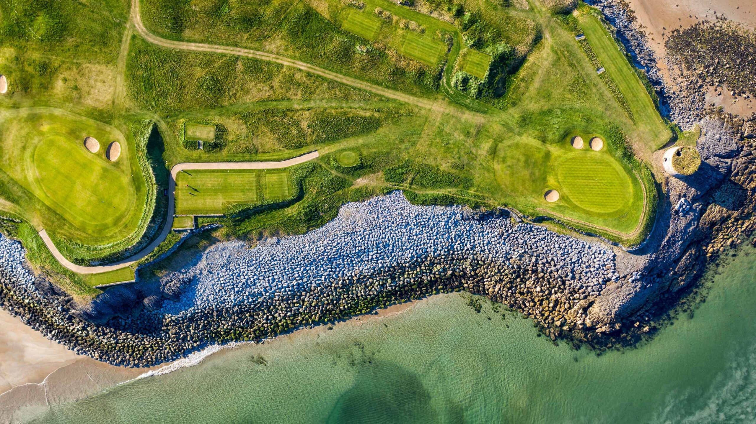 Aerial view of Tralee Golf Club's links coastline and Martello tower, Ireland